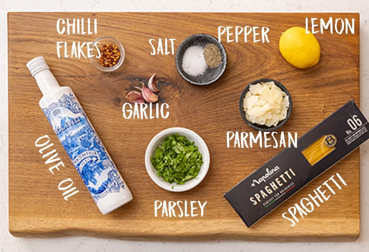 Ingredients for Spaghetti aglio e olio on a wooden board