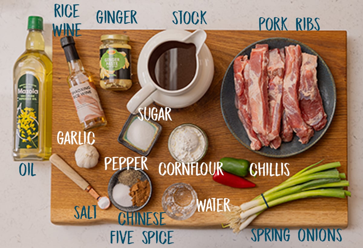 Ingredients for salt and pepper ribs on a wooden board.
