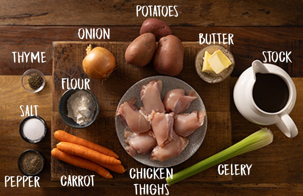 Ingredients for chicken stew on a wooden board