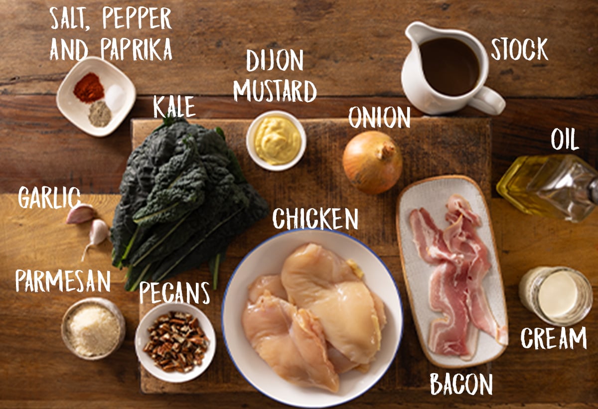 Individual labeled ingredients for a creamy chicken dijon recipe on a wooden board.