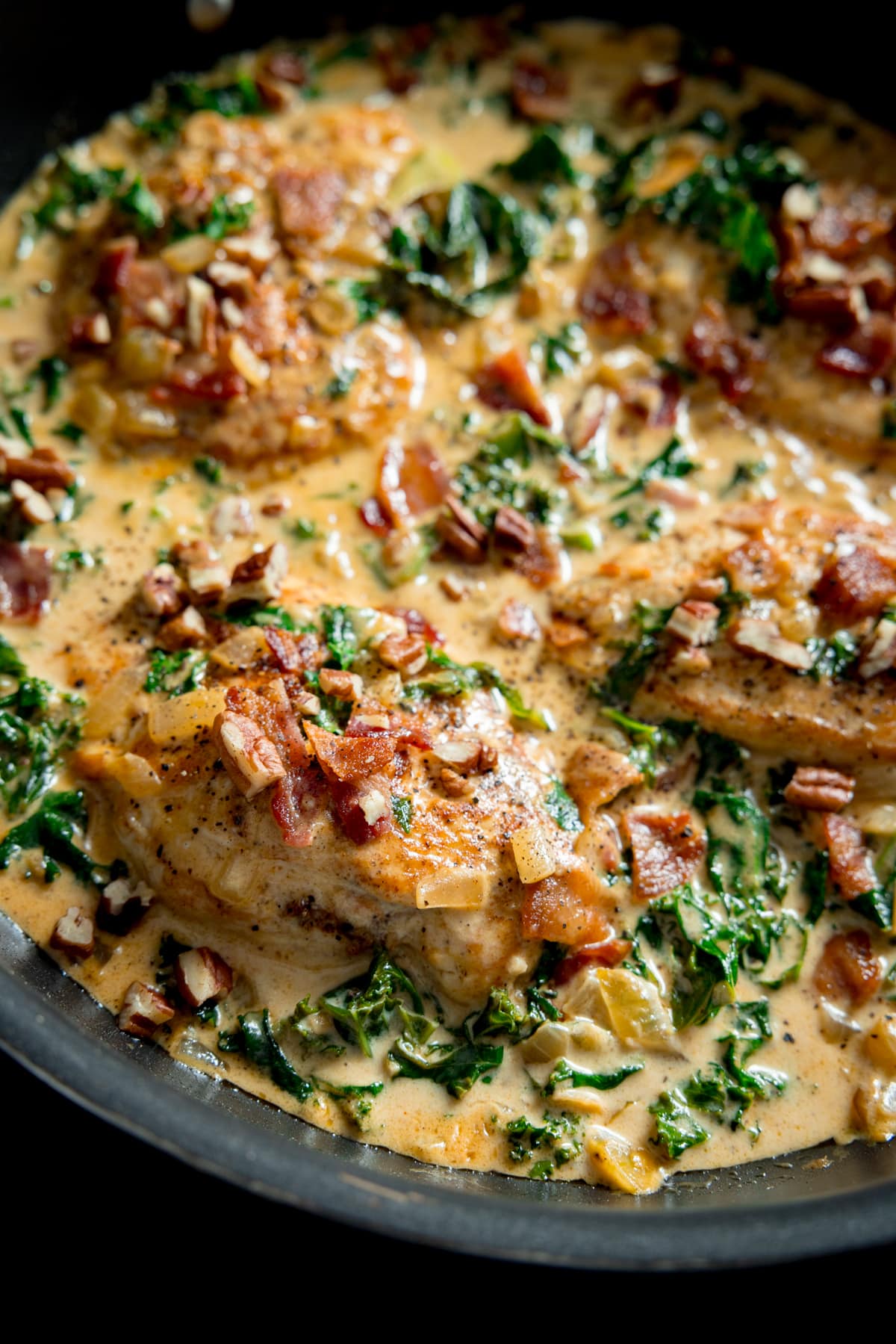 Close up picture of creamy chicken dijon in a grey frying pan.  