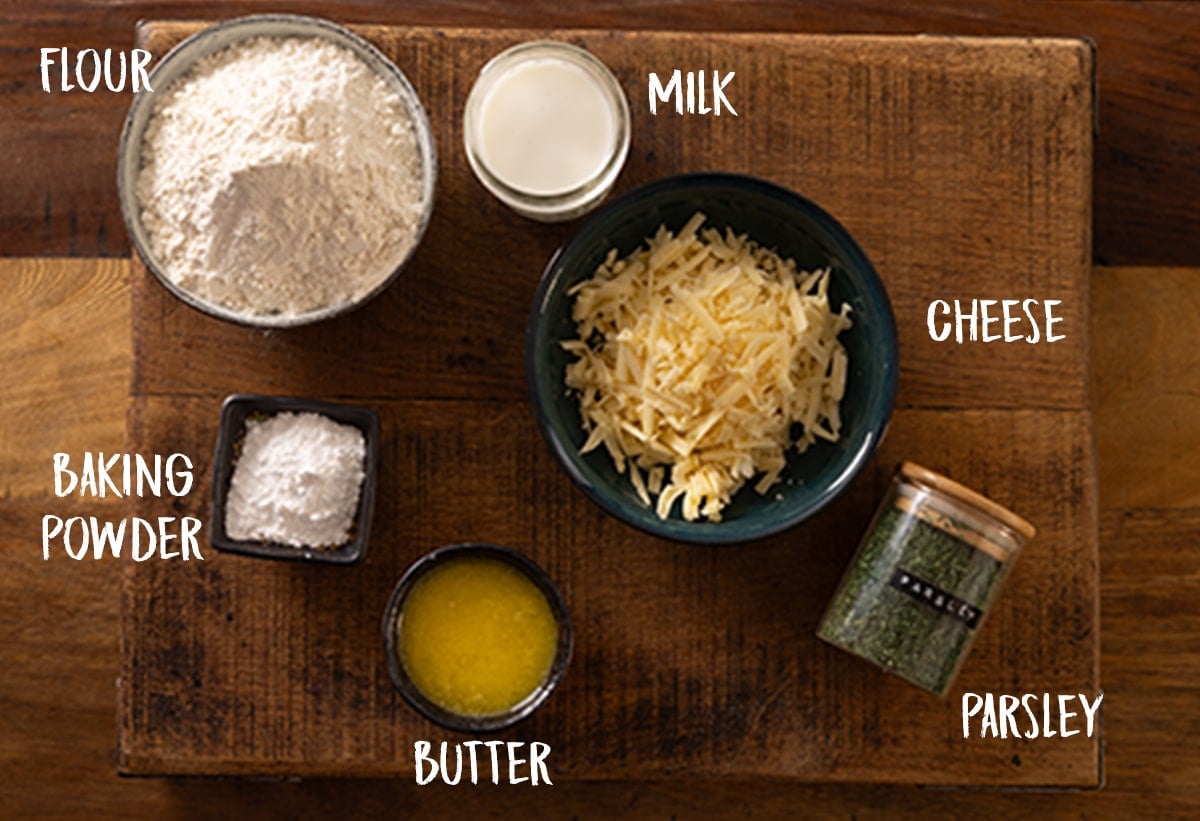 Ingredients for Cheddar dumplings on a wooden board.