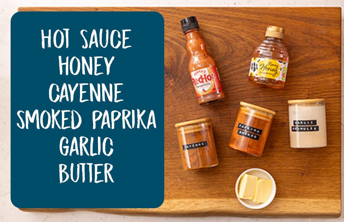 Ingredients for hot honey sauce on a wooden board. There is a blue text box with the list of ingredients on the left.