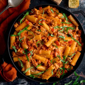 Overhead photo of a black frying pan full of spicy sausage rigatoni.