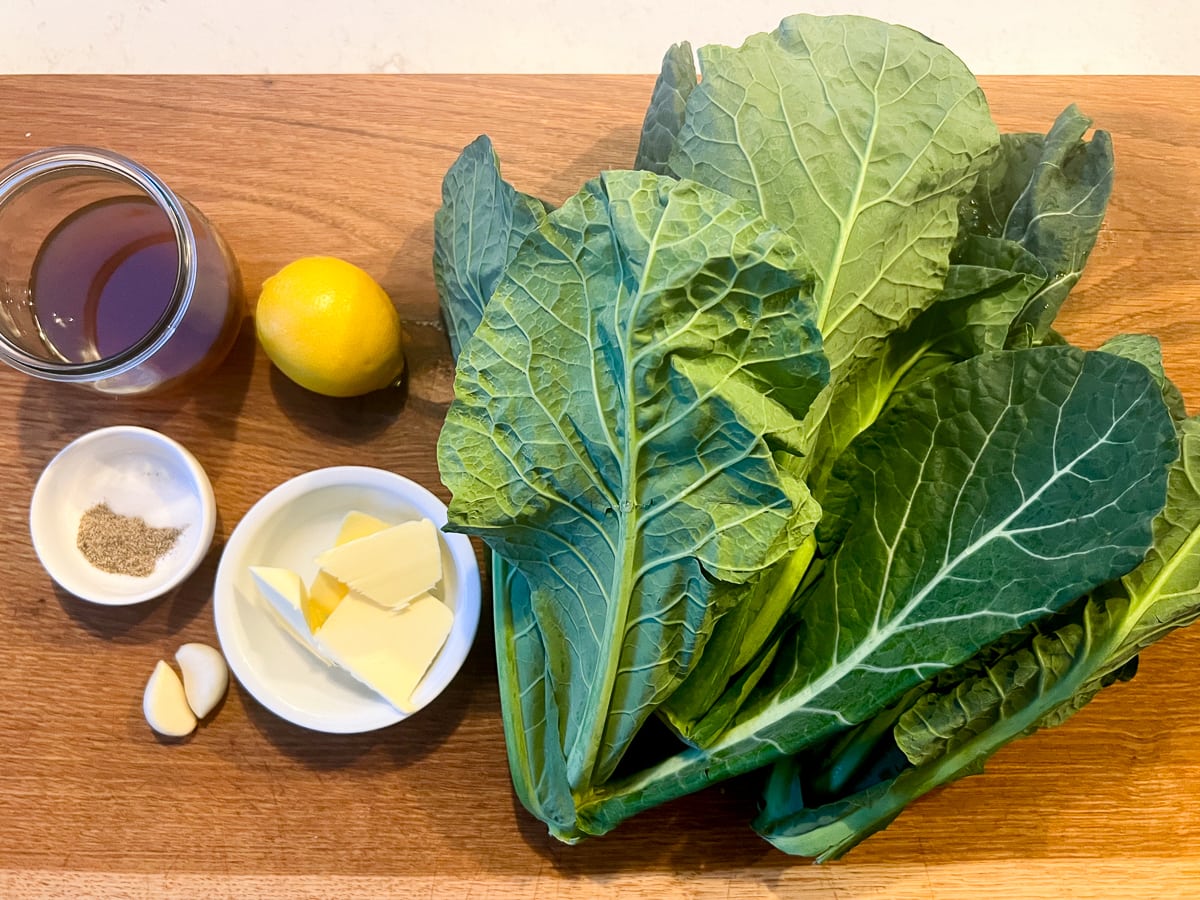 Ingredients for sauteed spring greens on a wooden board