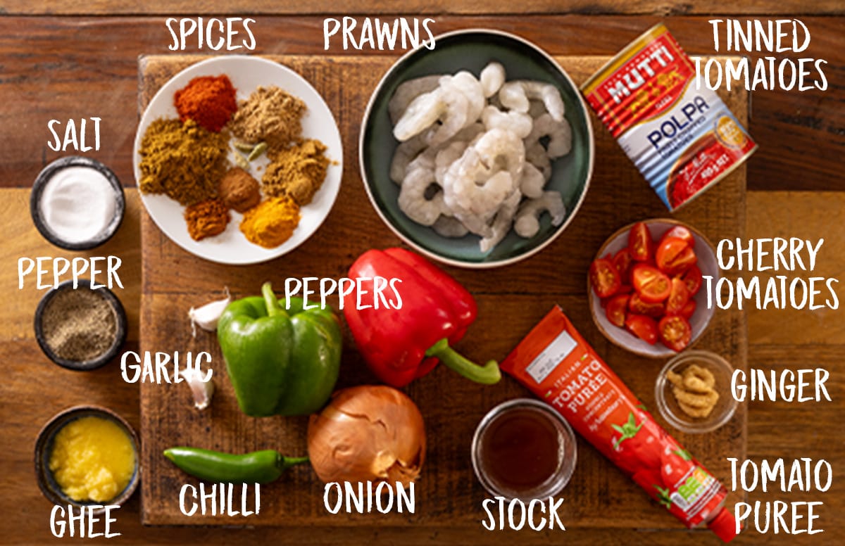 Picture of labelled ingredients for a prawn balti curry on a wooden board.