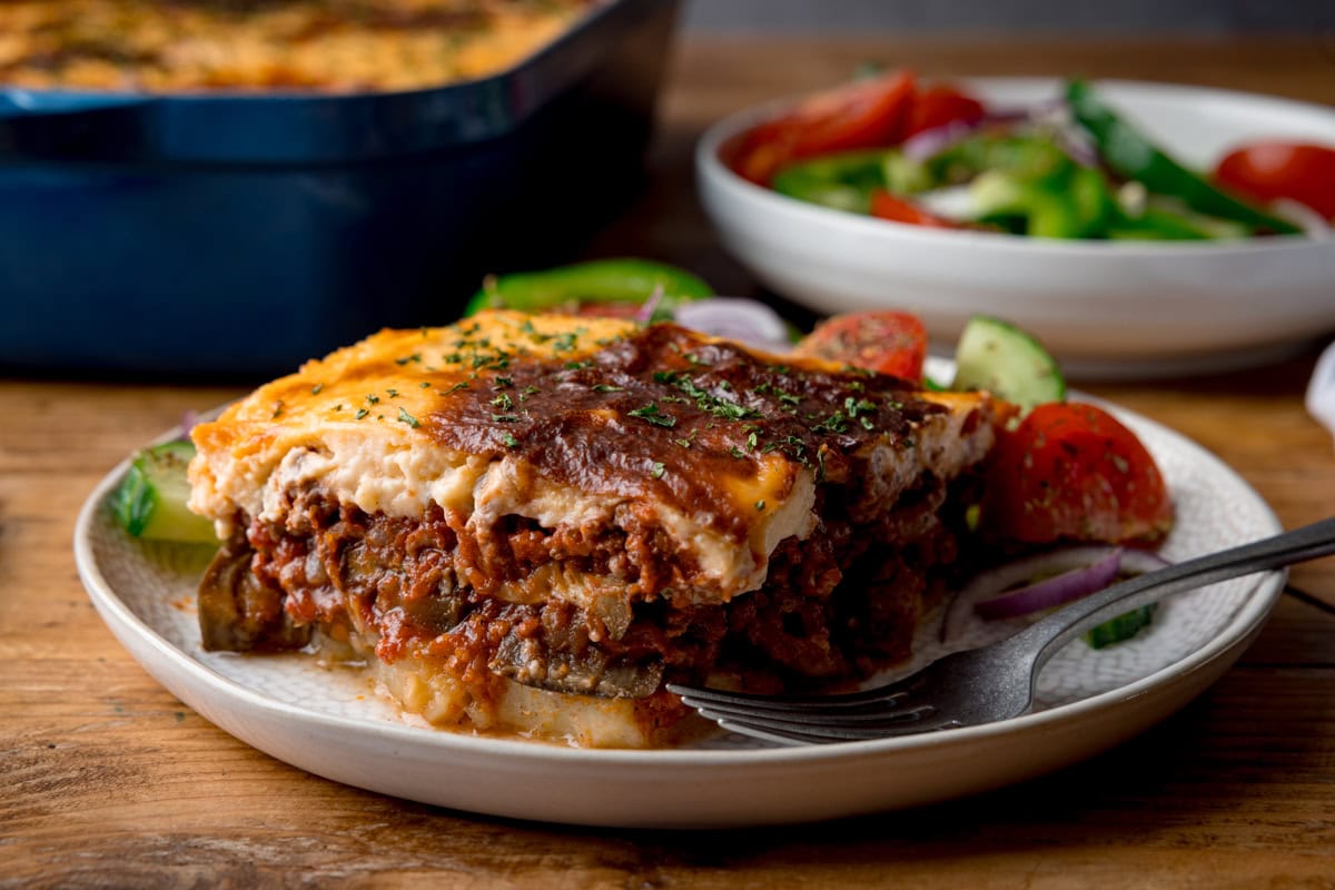Layers of tomato minced lamb, potatoes and aubergine topped with cheese sauce