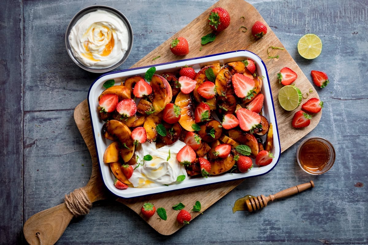 Griddled peaches, pineapple, plums and mango topped with strawberries and Greek yoghurt