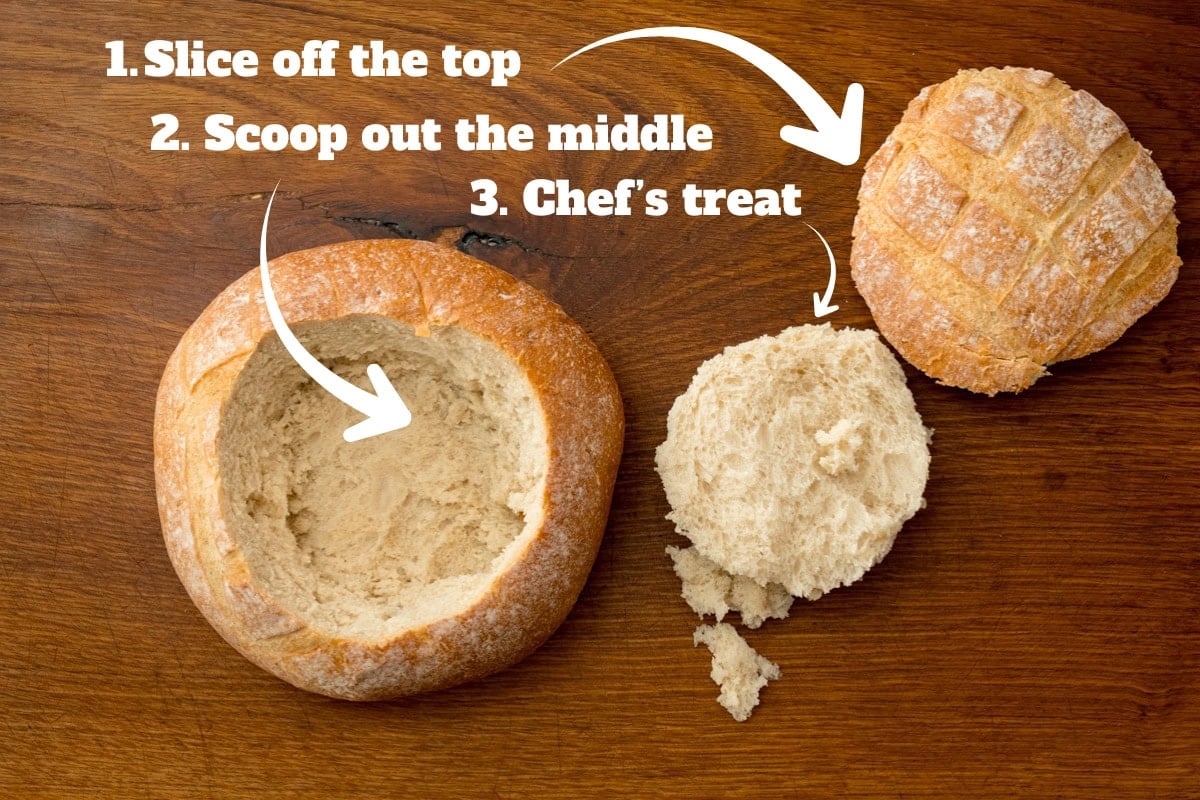 A round loaf of bread with the top sliced off, the inside scooped out and placed beside it.