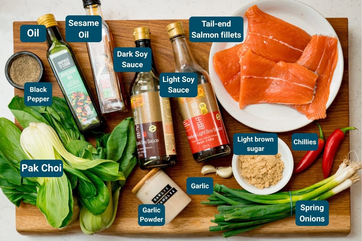 Ingredients for an Asian-inspired salmon dish: salmon fillets, pak choi, soy sauces, sesame oil, chillies, spring onions, brown sugar, black pepper, oil and garlic.