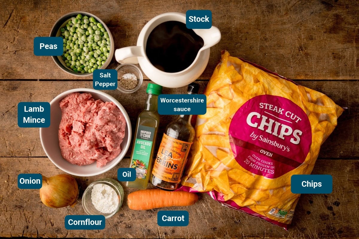 Ingredients for shepherd’s pie loaded fries, including lamb mince, frozen peas, carrot, onion, cornflour, seasonings, oil, Worcestershire sauce, stock, and a bag of frozen steak-cut chips.